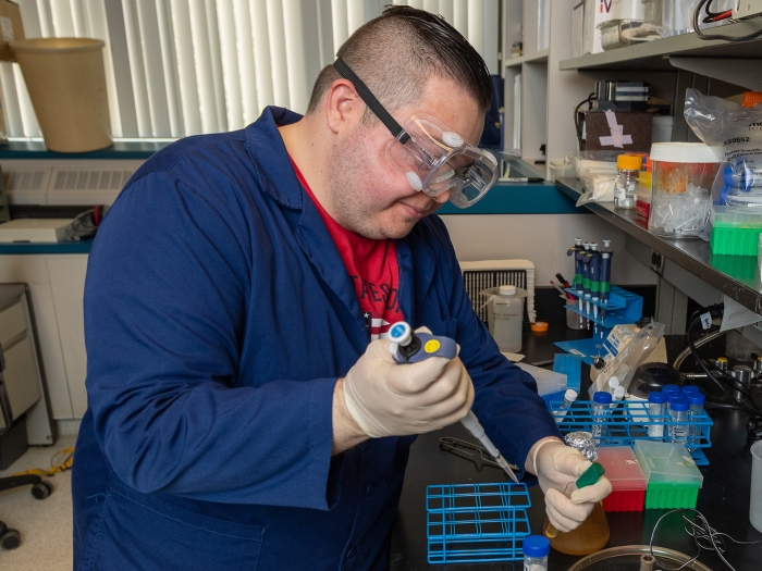 man using pipette in laboratory 