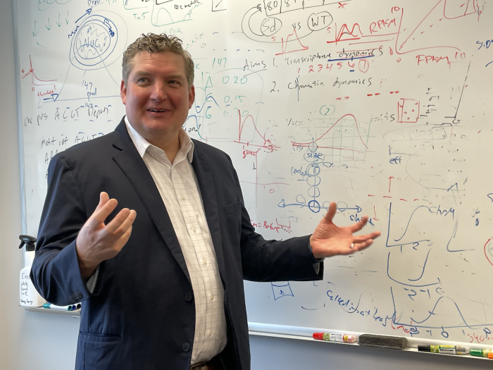 Professor Stephen Parker stands in his office