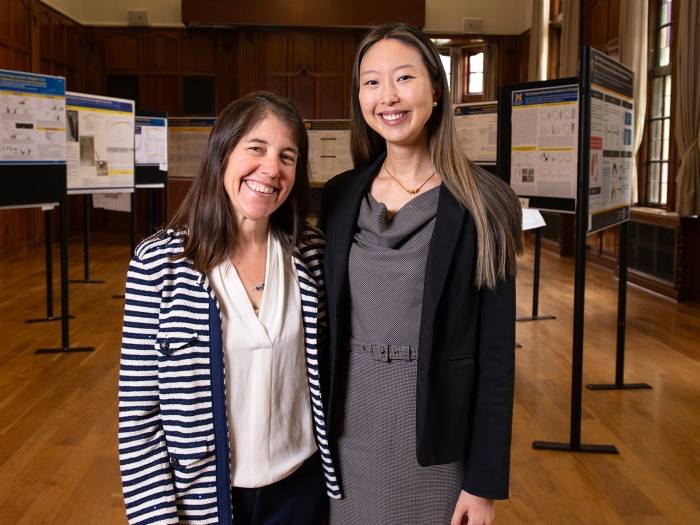 two women posing together smiling 