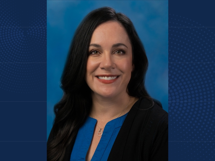 Headshot of Marisa Buchakjian, MD, PhD on a navy blue background