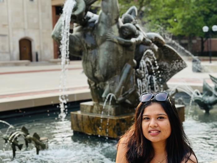 Hitarthi sitting next to a fountain