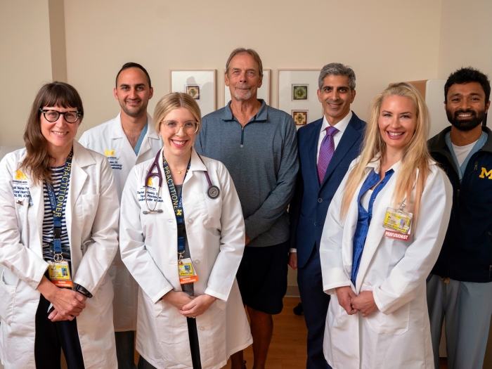 clinical team and patient standing together