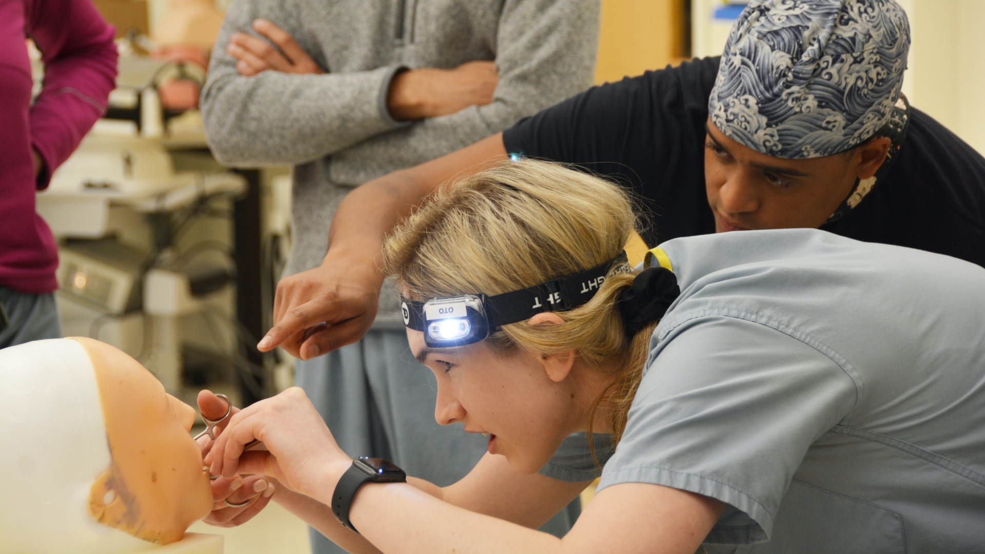 student in training working on a mannequin inside of the mouth 