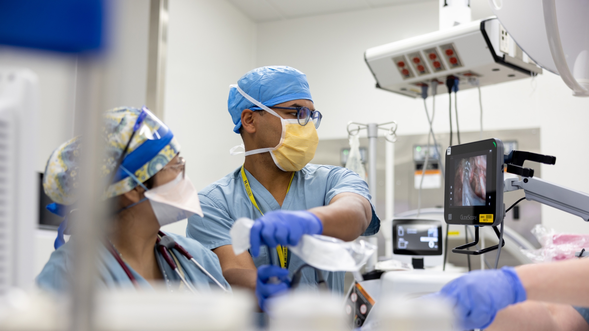 a group of people wearing scrubs and surgical caps in OR