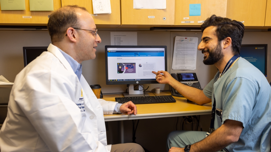 physician and doctor at a computer 