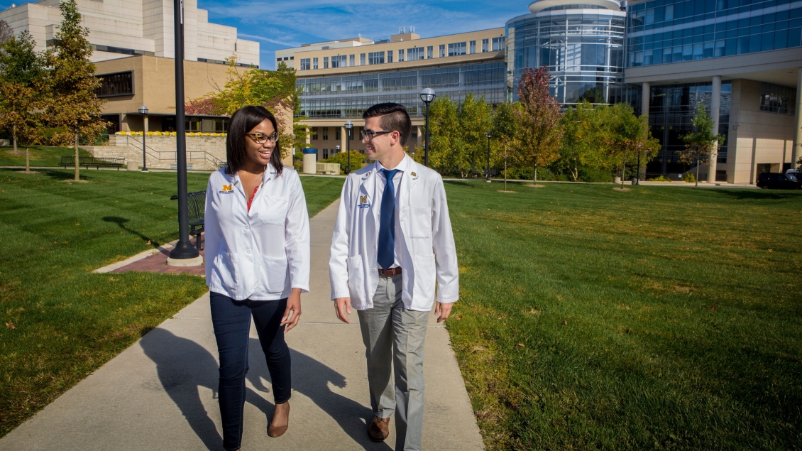 Two people walking on the U-M medical campus