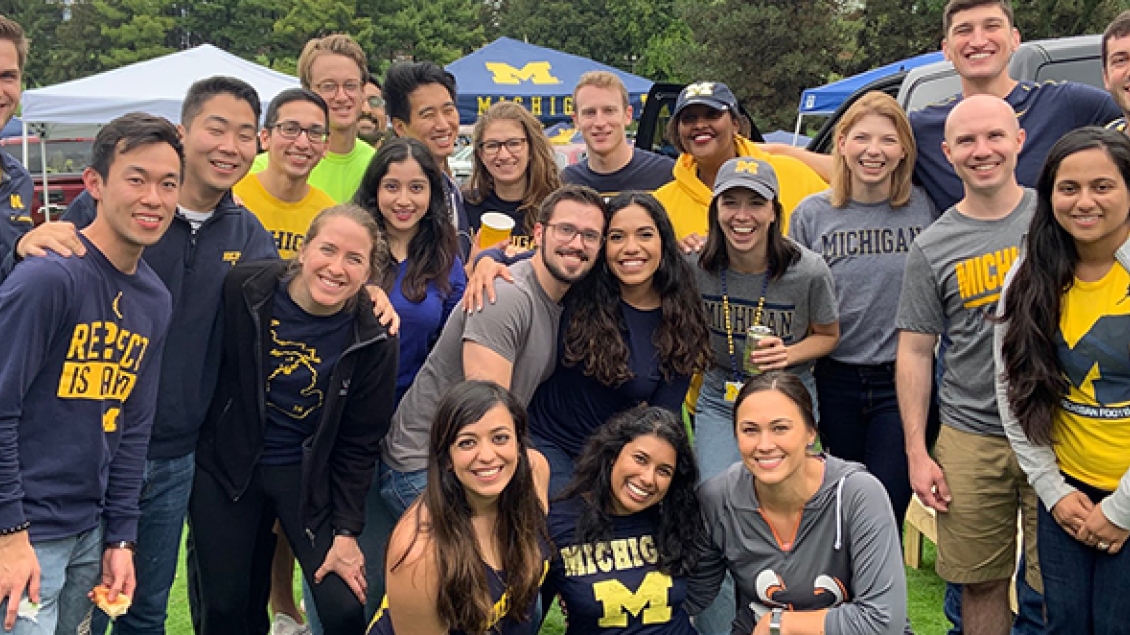 Residents smile for photo at Michigan football game tailgate