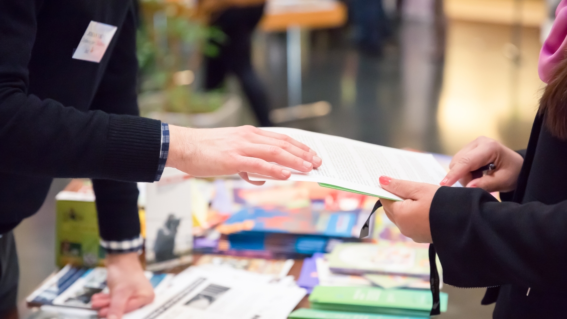 Hand over work materials on table