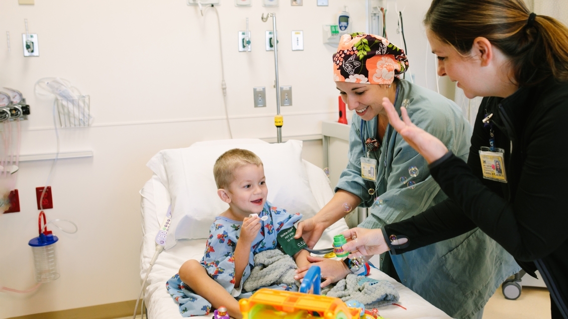 Two doctors working with a pediatric patient