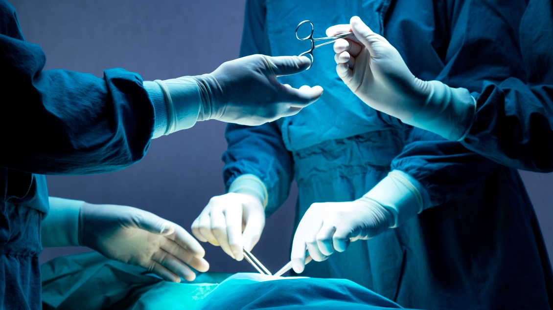 Medical professional operating on patient in surgical setting