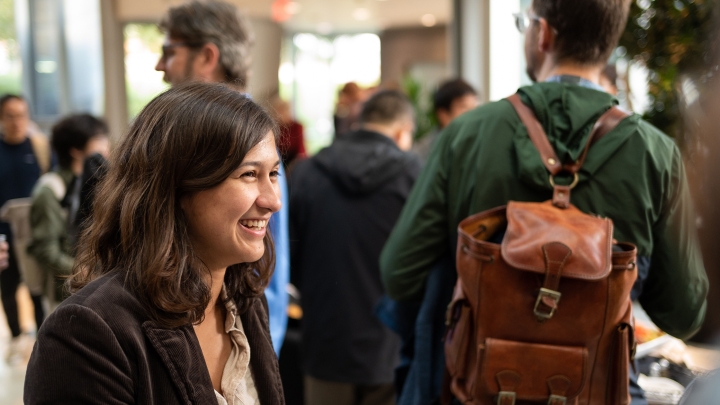  Smiling student holding a plate of appetizers.