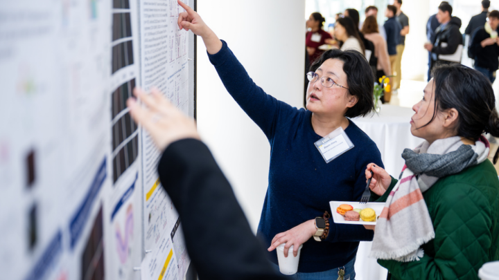 Dermatology researchers look at a poster