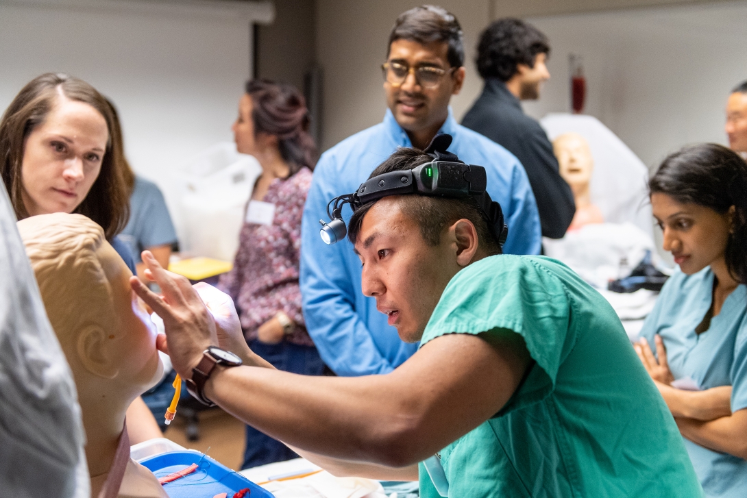 Otolaryngology student practices an exam in the simulation lab