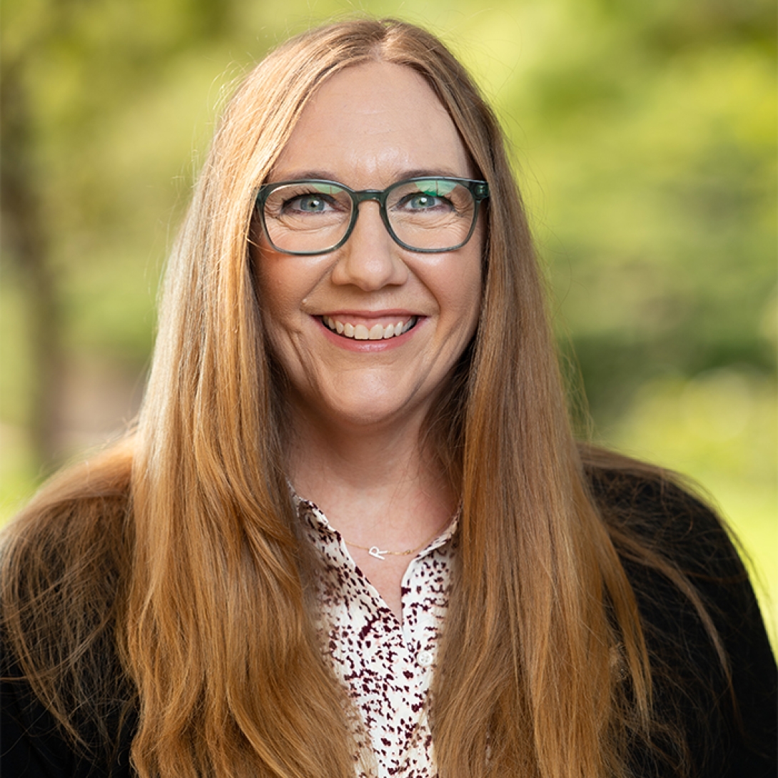 Rebekah Ashley head and shoulders with trees in background