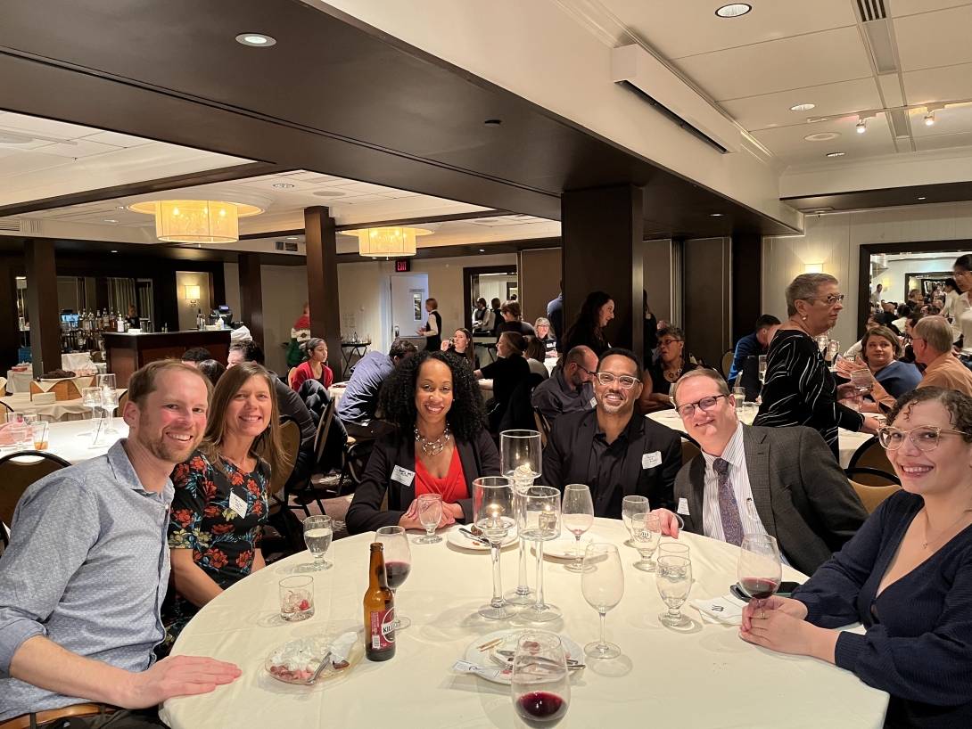 Pharmacology staff smile at a banquet event