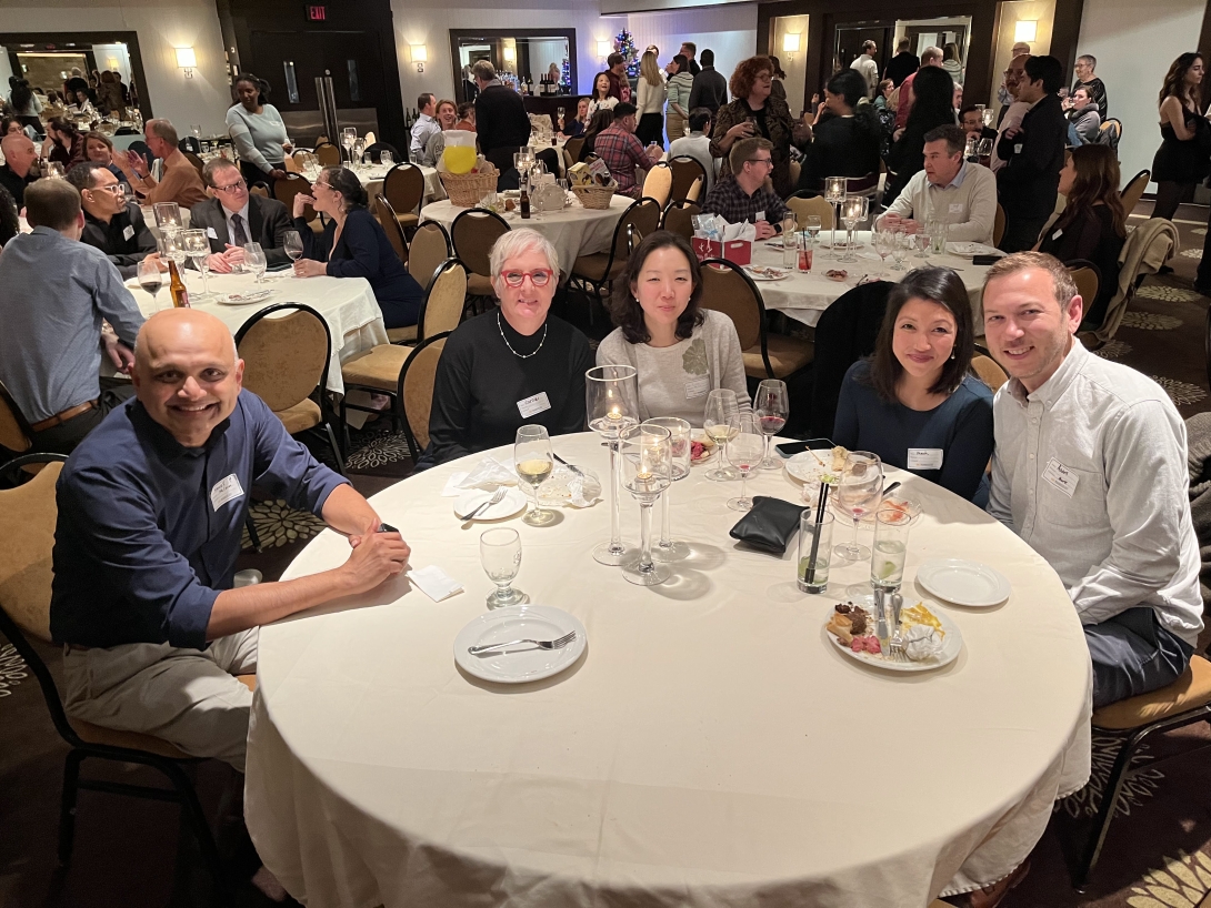 Pharmacology staff smile at a banquet event