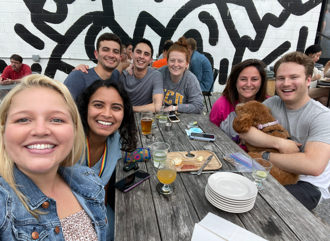 Residents smile for a photo outside on a patio