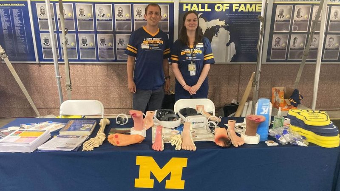 Two people standing at an event table