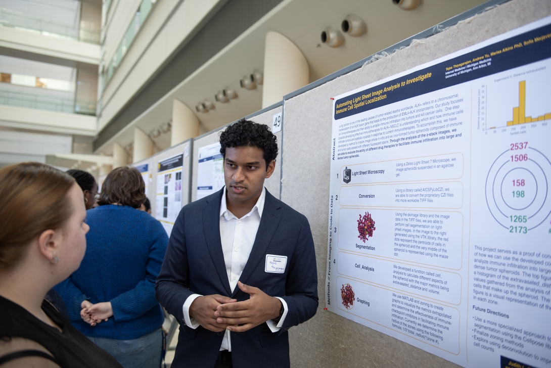 PhD students looking at a poster