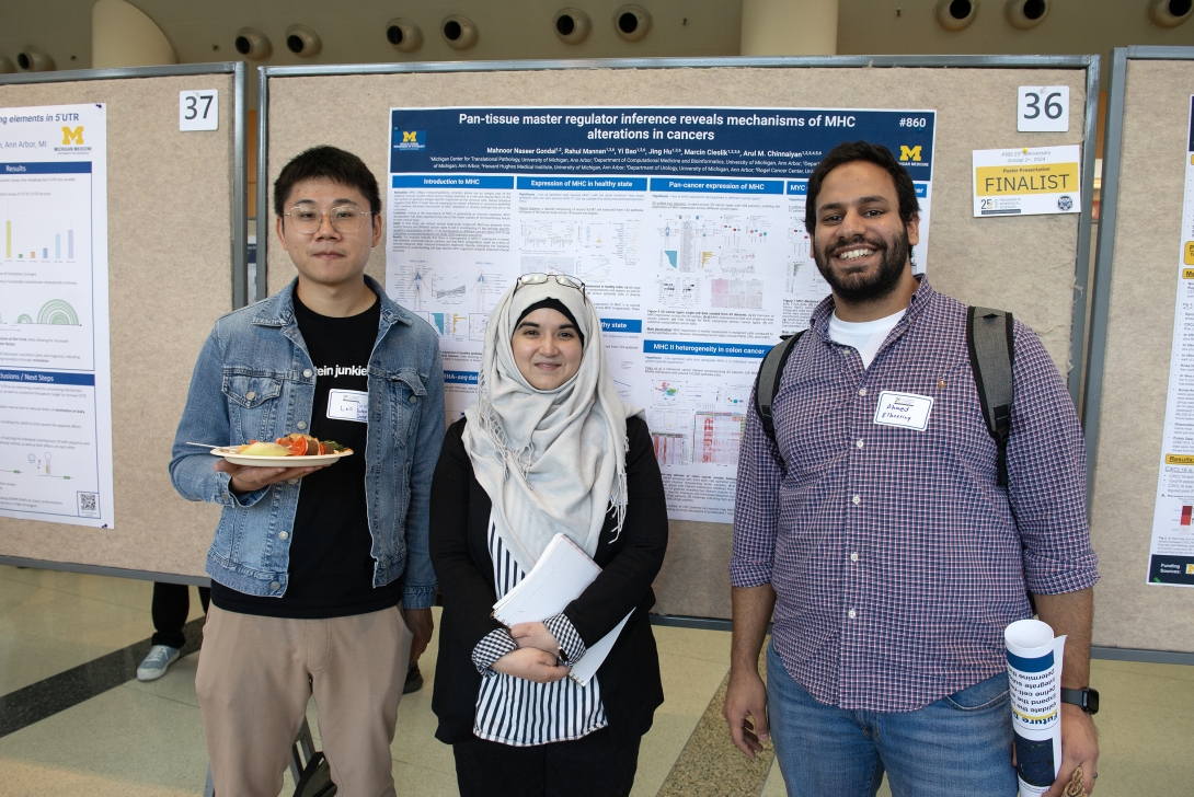 PhD students in front of a poster